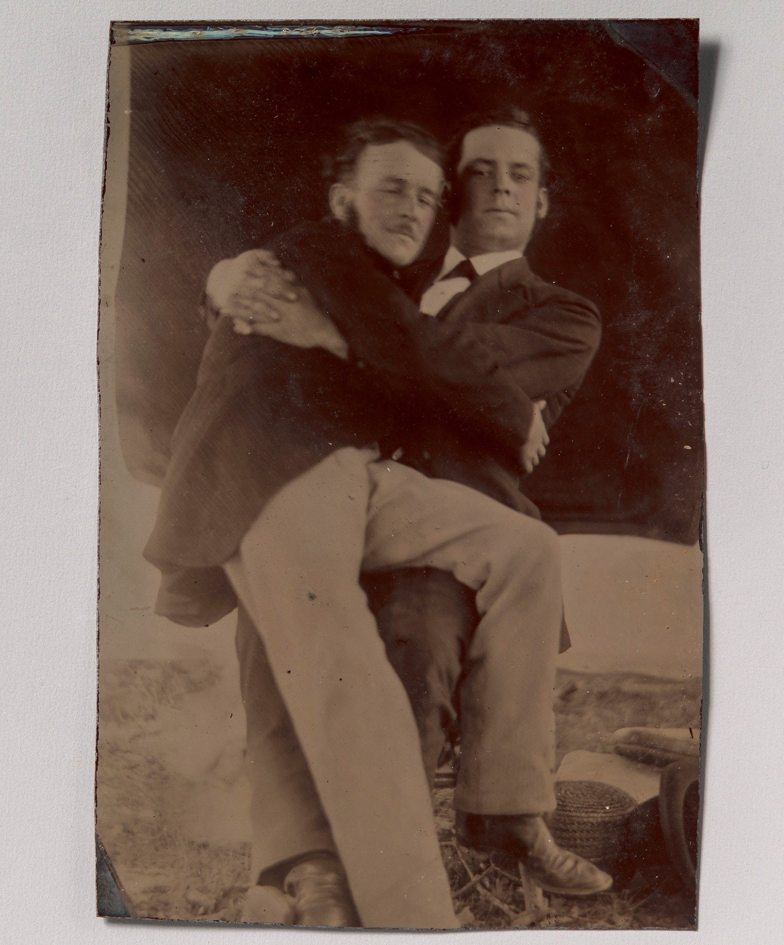 Двое мужчин в объятиях, один сидит на коленях у другого; тинтайп, фотография неизвестного автора, 1880–1890-е годы